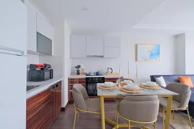 a kitchen and dining room with a table and chairs at Modern Furnished Apartments in Istanbul Basaksehir By Iradah Gayrimenkul in Basaksehir