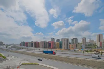 a highway with a city in the background at Modern Furnished Apartments in Istanbul Basaksehir By Iradah Gayrimenkul in Basaksehir