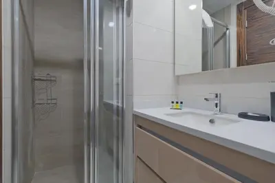 a bathroom with a shower and a sink at Modern Furnished Apartments in Istanbul Basaksehir By Iradah Gayrimenkul in Basaksehir