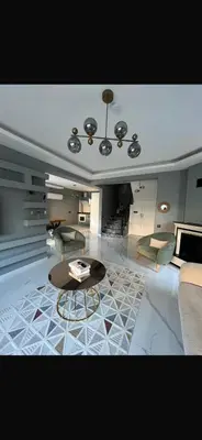 a living room with a table and a couch at Lina Garden Villa in Sapanca