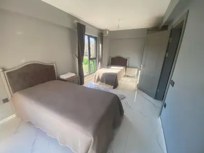 a bedroom with two beds and a large window at Lina Garden Villa in Sapanca
