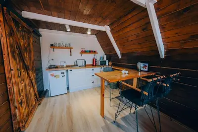a kitchen with a wooden ceiling and a wooden table at Mert Bungalov-Ay Evi in Sapanca