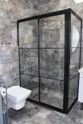 a bathroom with a shower and a toilet at City Night Hotels Ümraniye in Umraniye