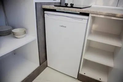 a white dishwasher in a kitchen under a counter at Dream Flat in Istanbul