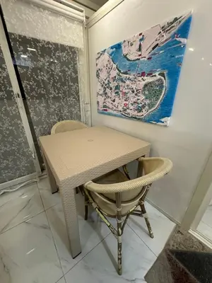 a table and chairs in a room with a painting at Dream Flat in Istanbul