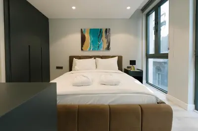 a bedroom with a large bed with a couch at DeCamondo Residence Karaköy in Istanbul