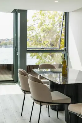 a table and chairs in a room with a large window at DeCamondo Residence Karaköy in Istanbul