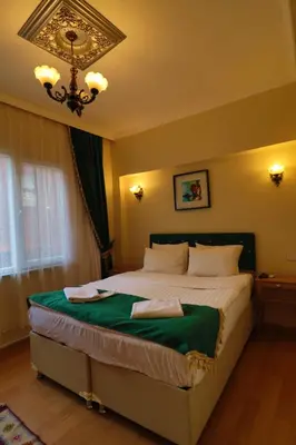 a bedroom with a large bed with a chandelier at Stone Home Apart in Istanbul