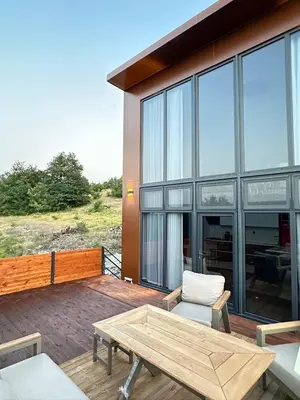 a patio with a wooden table and a chair at Loft Sabırlı in Kaynarca