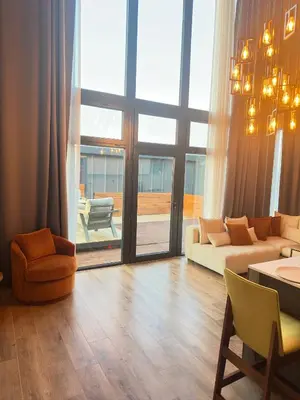 a living room with a couch and a table at Loft Sabırlı in Kaynarca