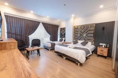 a hotel room with two beds and a piano at Highway 34 Hotel in Istanbul