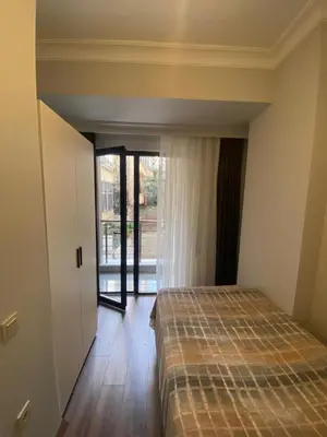 a bedroom with a bed in a room with a window at Şişli Merkezde Konforlu Daire in Istanbul