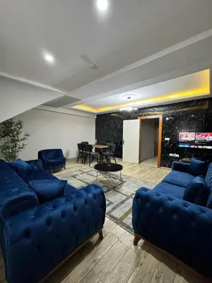 a living room with blue couches and a table at White Wonder Suites in Istanbul