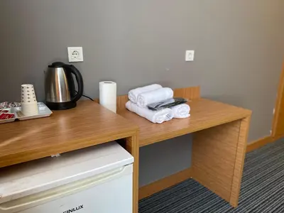 a wooden desk with towels and a coffee maker on it at Tuyap Vip inn Hotels in Istanbul