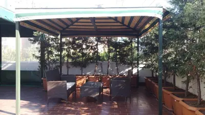a pavilion with chairs and a table and some plants at Tuyap Vip inn Hotels in Istanbul