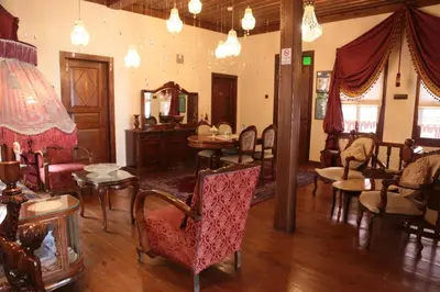 a living room with chairs and tables and a mirror at Aslibey Konaği - Adults Only in Sapanca