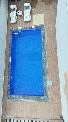 an overhead view of a swimming pool with two chairs at Luxury Villa with Private Pool Garden Lake View in Sapanca in Sapanca