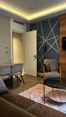 a living room with chairs and a table and a door at Taksim Flat Apartment in Istanbul