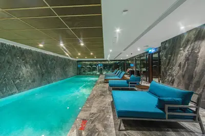 a swimming pool in a hotel with blue lounge chairs at Naz City Hotel Taksim - Special Category in Istanbul