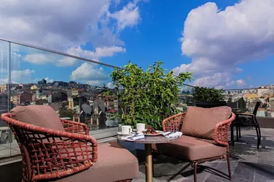 two chairs and a table on a balcony with a view at Naz City Hotel Taksim - Special Category in Istanbul