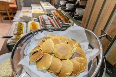 a buffet line of food with buns and other foods at Ayramin Deluxe Hotel Taksim in Istanbul