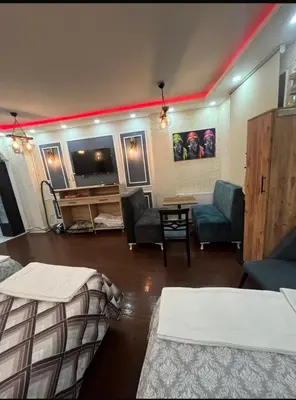 a room with two beds and a flat screen tv at Müstakil kat 2 in Istanbul