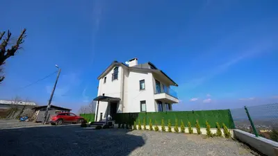 a white house with a fence in front of it at 4 Mevsim Konak in Kartepe