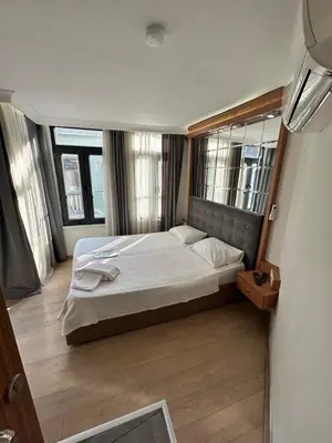 a bedroom with a large bed in a room with windows at Viva Sirkeci Butik Hotel in Istanbul