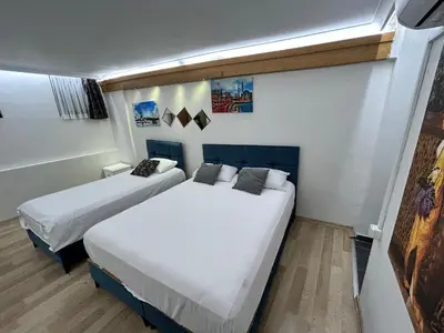 two beds in a small room with white sheets at Viva Sirkeci Butik Hotel in Istanbul