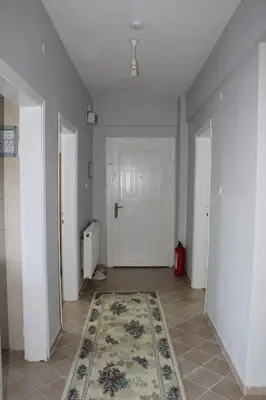 an empty hallway with a rug and a white door at Bosphorus view apartment Sarıyer in Sarıyer