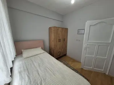 a small bedroom with a bed and a door at Bosphorus view apartment Sarıyer in Sarıyer