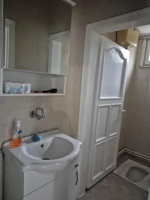 a bathroom with a sink and a white door at Bosphorus view apartment Sarıyer in Sarıyer