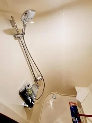 a lamp on a wall next to a sink at Den Den İstanbul in Istanbul