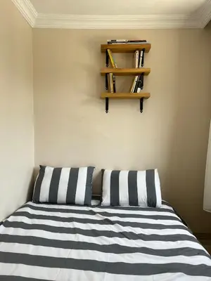 a bedroom with a bed with black and white striped pillows at K&Y Taksim Rooftop in Istanbul