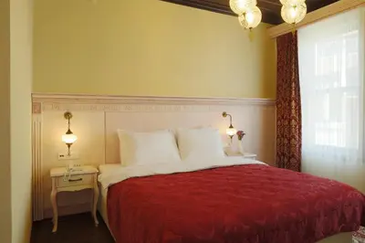 a bedroom with a red bed and a window at Bursa İpekyolu Hotel in Bursa