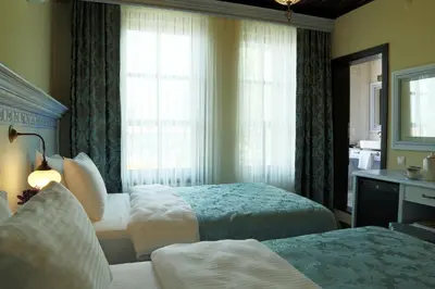 a hotel room with two beds and a window at Bursa İpekyolu Hotel in Bursa