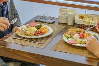 a table with two plates of food on it at Mekanhan Hotel in Gebze