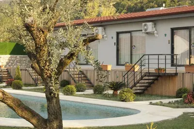 a house with a swimming pool in front of a house at Golyaka Stone Garden Hotel in Orhangazi