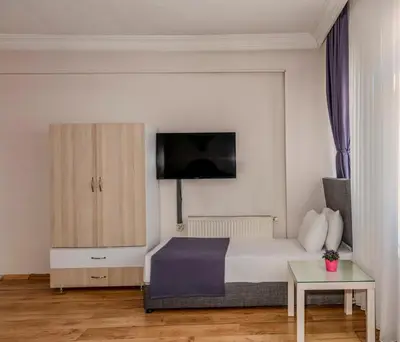 a bedroom with a bed and a tv on the wall at Brk Dream Suites Taksim in Istanbul