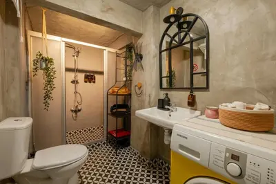 a bathroom with a toilet and a sink and a mirror at Studio Apartment in Istanbul