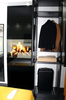 a room with a fireplace and a stove with a fire at Istanbul Fair Hotel in Istanbul