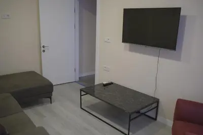 a living room with a couch and a tv on the wall at STS Hotel Luleburgaz in Lüleburgaz