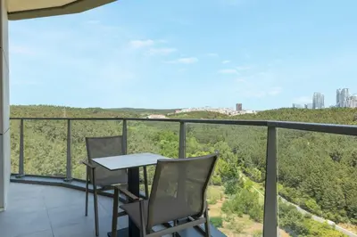 a balcony with two chairs and a table with a view at Marriott Executive Apartments Istanbul Investvadi in Istanbul