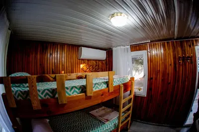 a bedroom with two bunk beds in a train car at Devrim Apart in Ocaklar