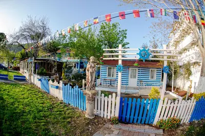 a fence in front of a house with a blue fence at Devrim Apart in Ocaklar