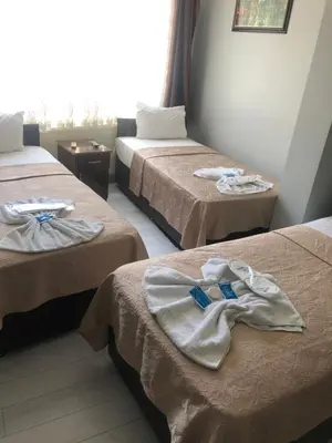 a hotel room with two beds with towels on them at Hotel Grand Ömer in Istanbul
