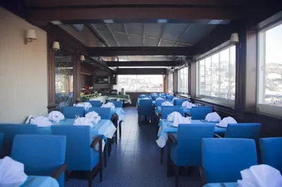 a dining room with blue tables and chairs at Golden Pen Hotel in Istanbul