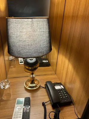a desk with a telephone and a lamp and a phone at Starmax City's Hotel YALOVA in Kâzımiye