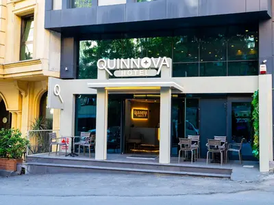 a restaurant with tables and chairs outside of a building at Quinnova Hotel in Istanbul