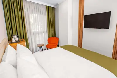 a hotel room with a bed and a television at Quinnova Hotel in Istanbul